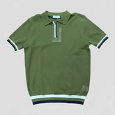 Green polo shirt with white and black trim on a light gray background